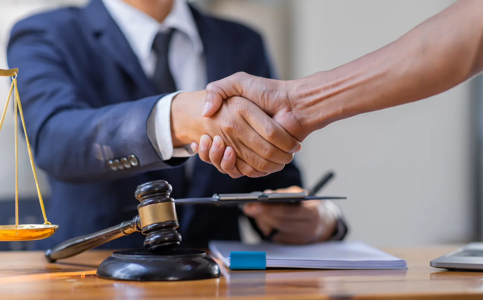 Attorney shaking hands with a client during a confidential consultation about filing a sexual abuse lawsuit in Missouri